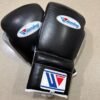 Winning black silver boxing gloves close-up of laces and padding