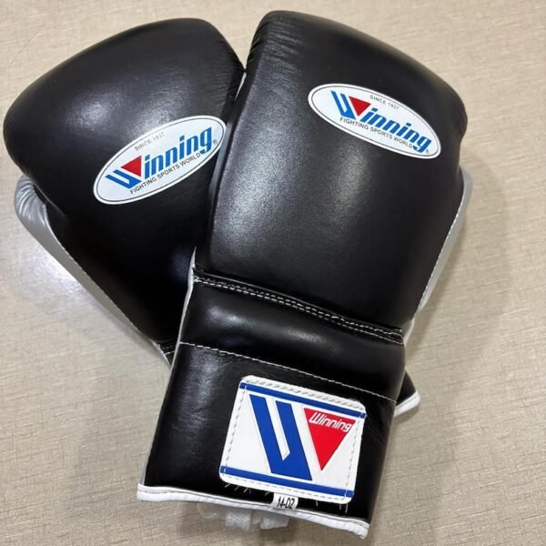 Winning black silver boxing gloves close-up of laces and padding
